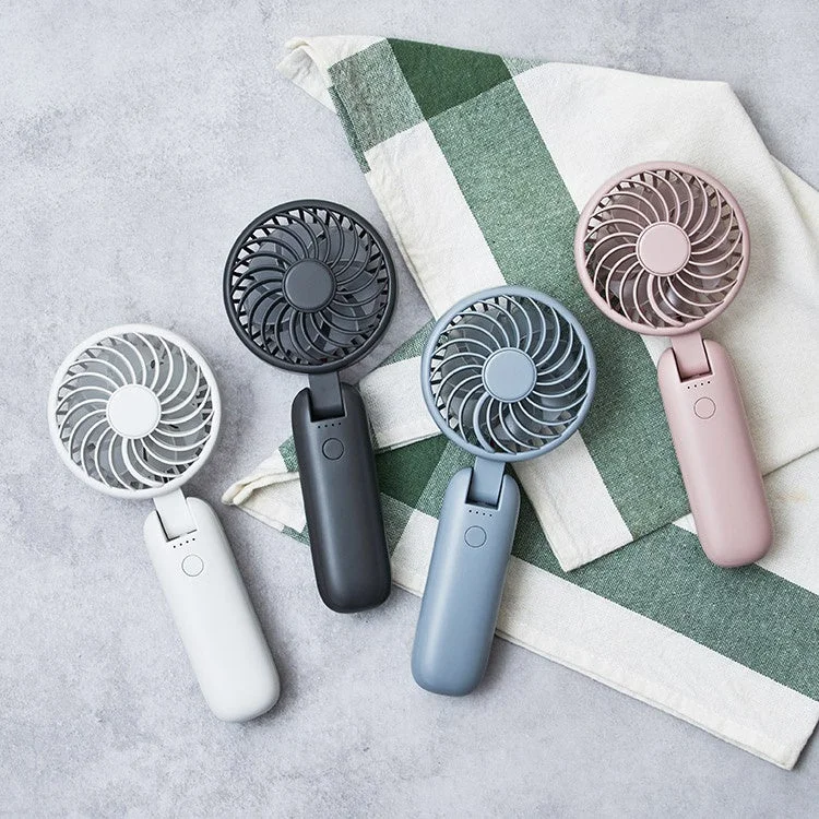 様々な色の折りたたみ式ハンディファンが4つ並べられている様子